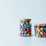 Zero Waste Lifestyle - two glass jars filled with candy beans on a white surface