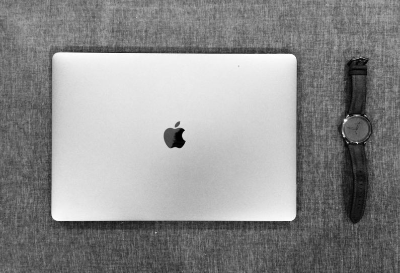 Electronics Recycling - silver macbook on brown textile
