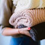 Home Recycling - person holding knitted textiles