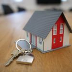 Property Tax - white and red wooden house miniature on brown table