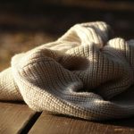 Knitted Blanket - white textile on wooden plank