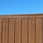 Yard Fencing - a wooden fence with a blue sky in the background