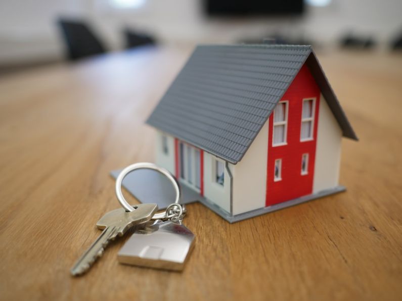 Real Estate - white and red wooden house miniature on brown table