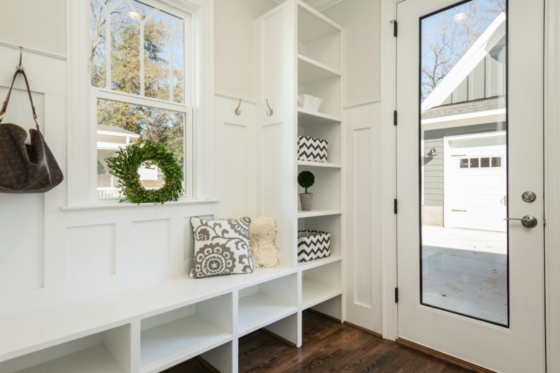 Mudroom - gray and white floral throw pillow beside rack inside room