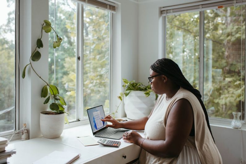 Home Office - a woman sitting at a table with a laptop